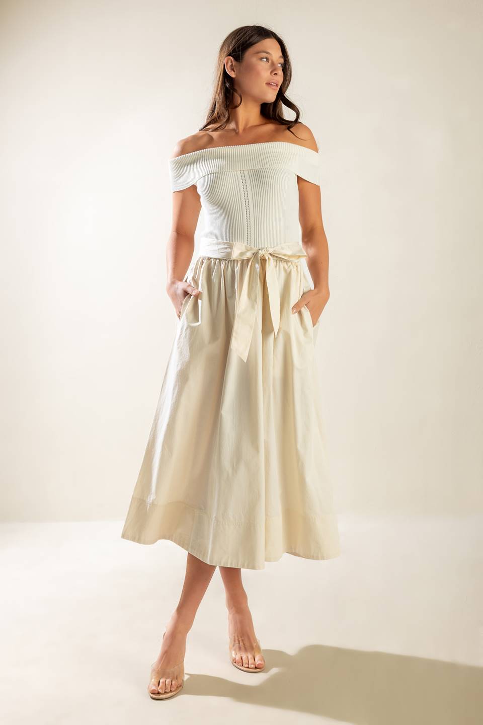 A sweater off shoulder top with full woven skirt and self sash belt.