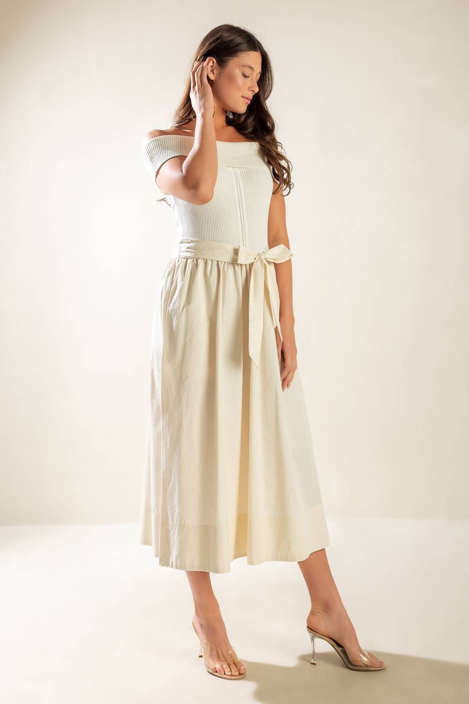 A sweater off shoulder top with full woven skirt and self sash belt.