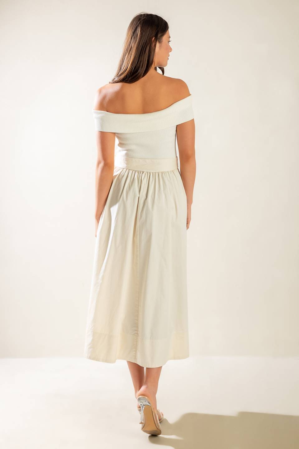 A sweater off shoulder top with full woven skirt and self sash belt.