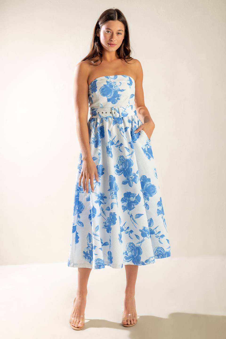 A strapless white and blue printed textured woven midi dress featuring self belt and full skirt.