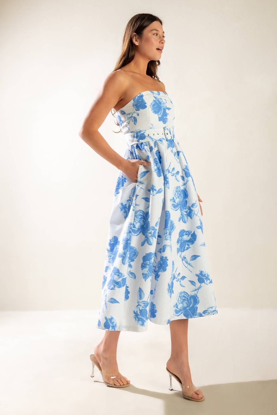 A strapless white and blue printed textured woven midi dress featuring self belt and full skirt.