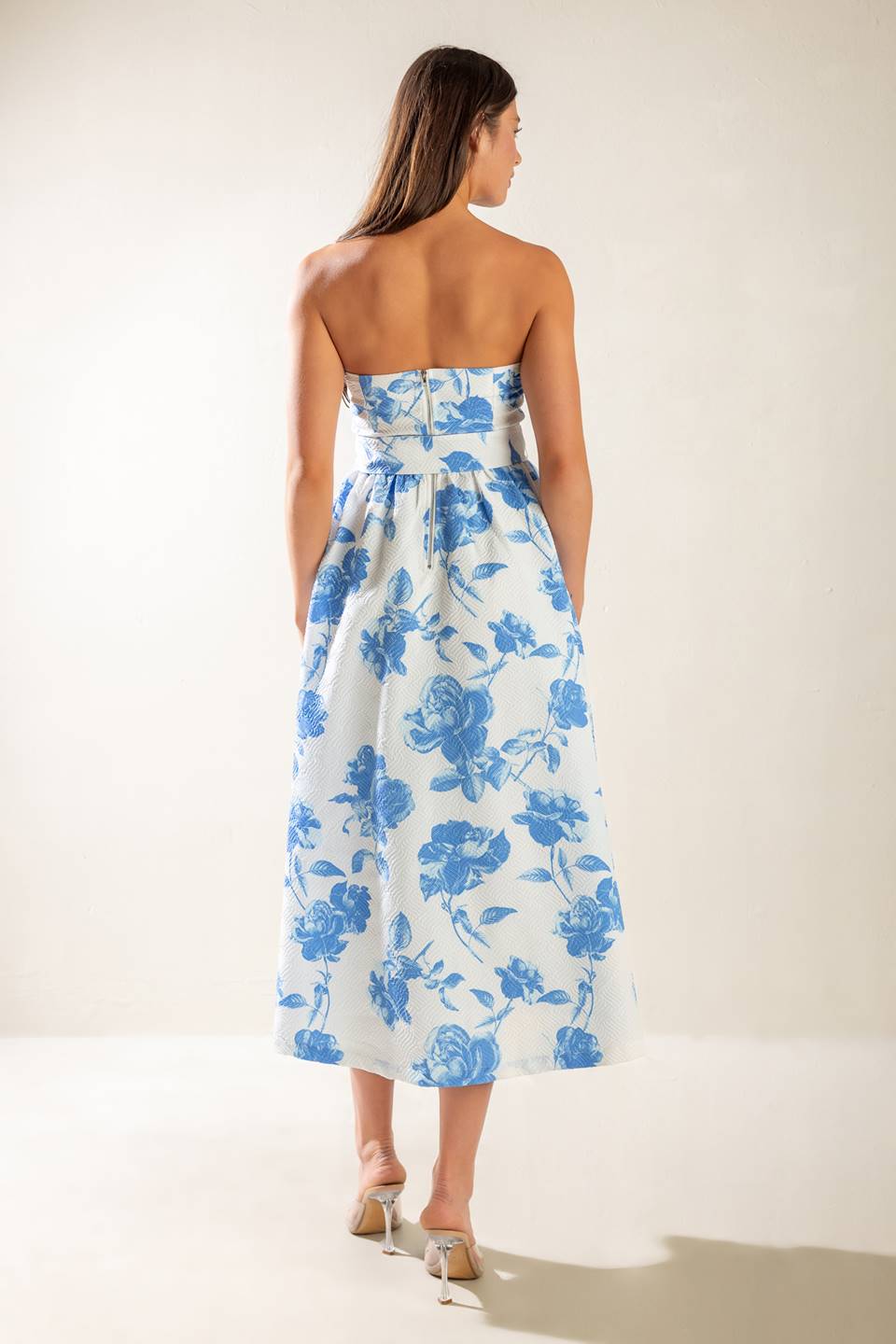 A strapless white and blue printed textured woven midi dress featuring self belt and full skirt.