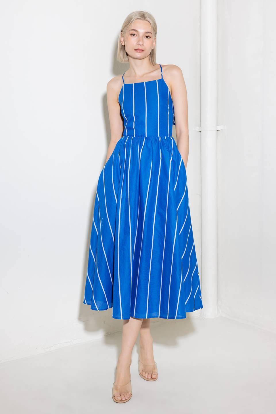 A blue and white striped woven midi dress featuring bib neckline, full skirt and bare back with strap and tie closure.
