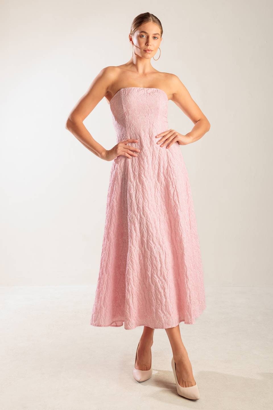 A textured pink woven midi dress featuring strapless, circle skirt and smocked back bodice with zipper closure