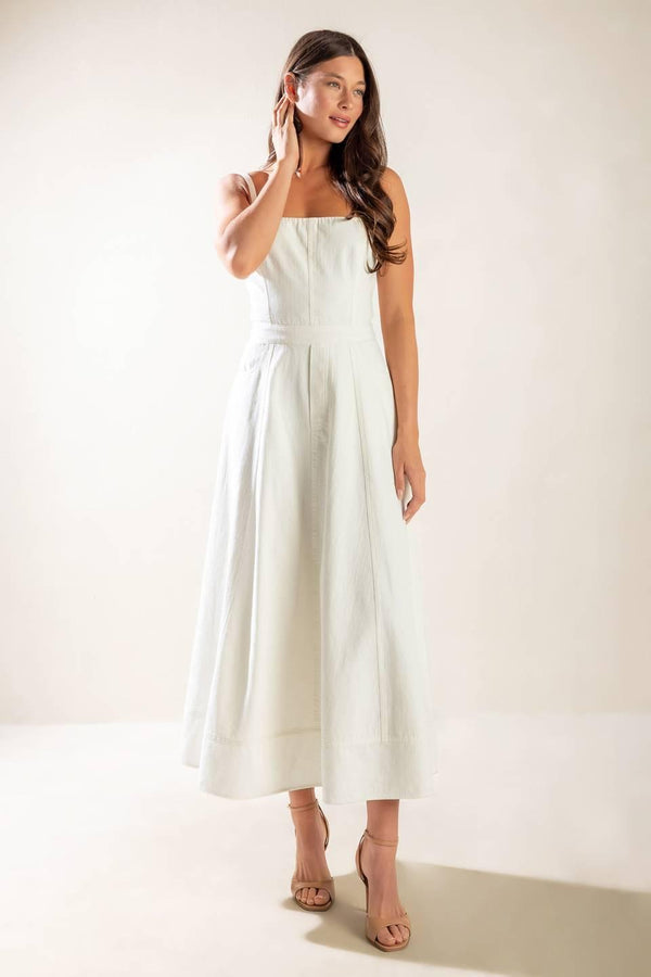 A solid white woven midi dress featuring straight neckline, straps, side pockets, circle skirt, bare back with tie and zipper closure.