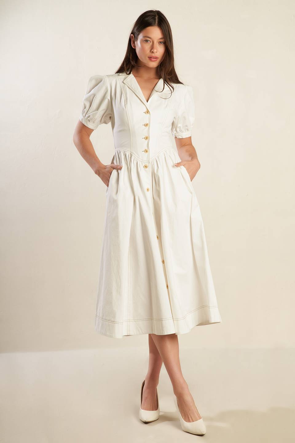 A solid off-white woven midi dress featuring collar, button down, short puff sleeve with cuff and full skirt.