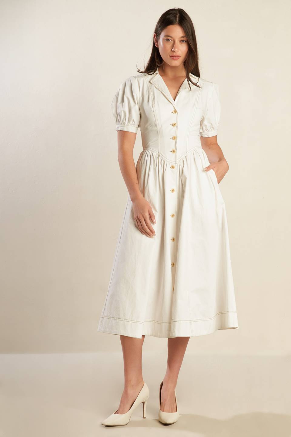 A solid off-white woven midi dress featuring collar, button down, short puff sleeve with cuff and full skirt.