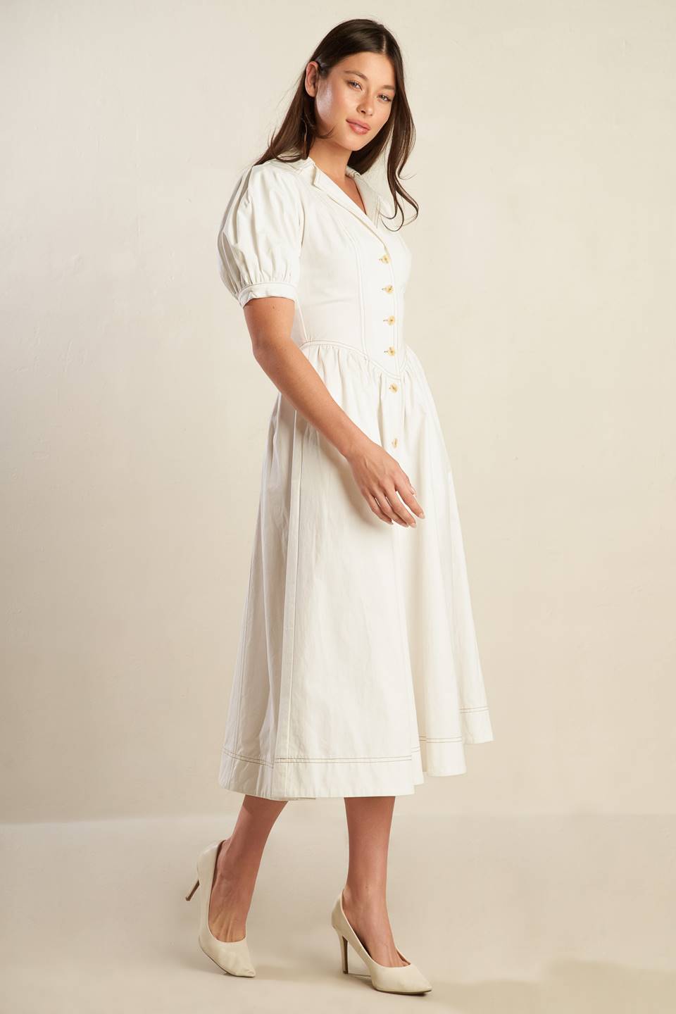 A solid off-white woven midi dress featuring collar, button down, short puff sleeve with cuff and full skirt.