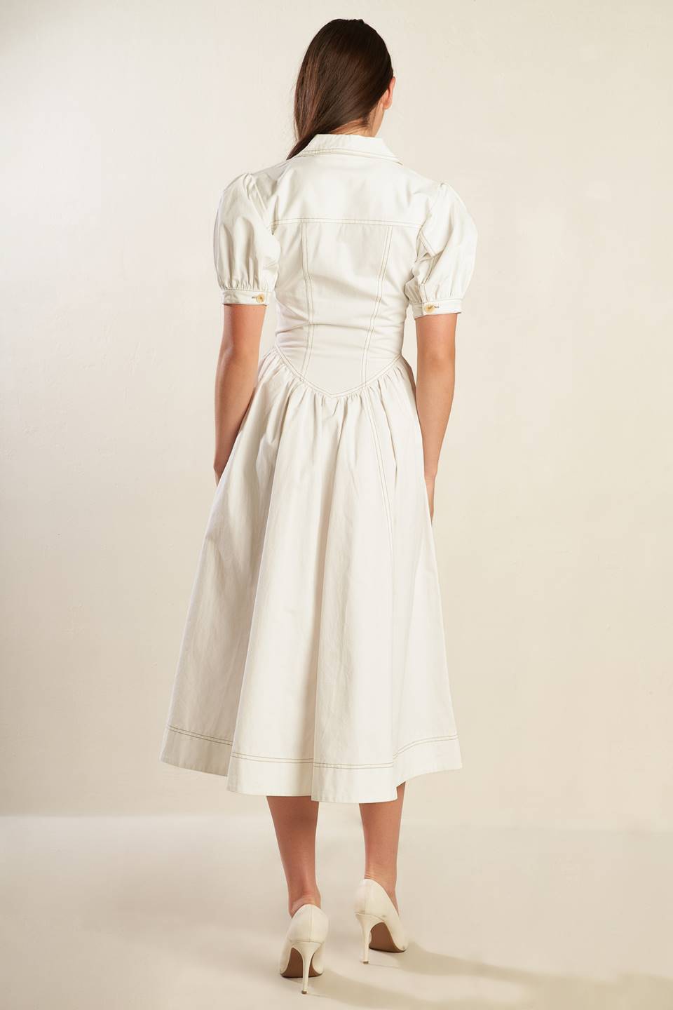 A solid off-white woven midi dress featuring collar, button down, short puff sleeve with cuff and full skirt.