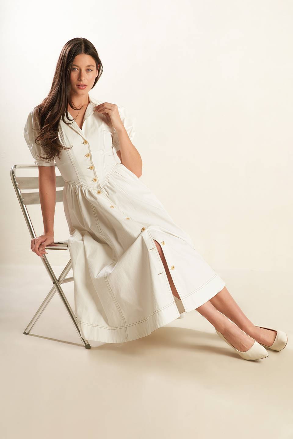 A solid off-white woven midi dress featuring collar, button down, short puff sleeve with cuff and full skirt.