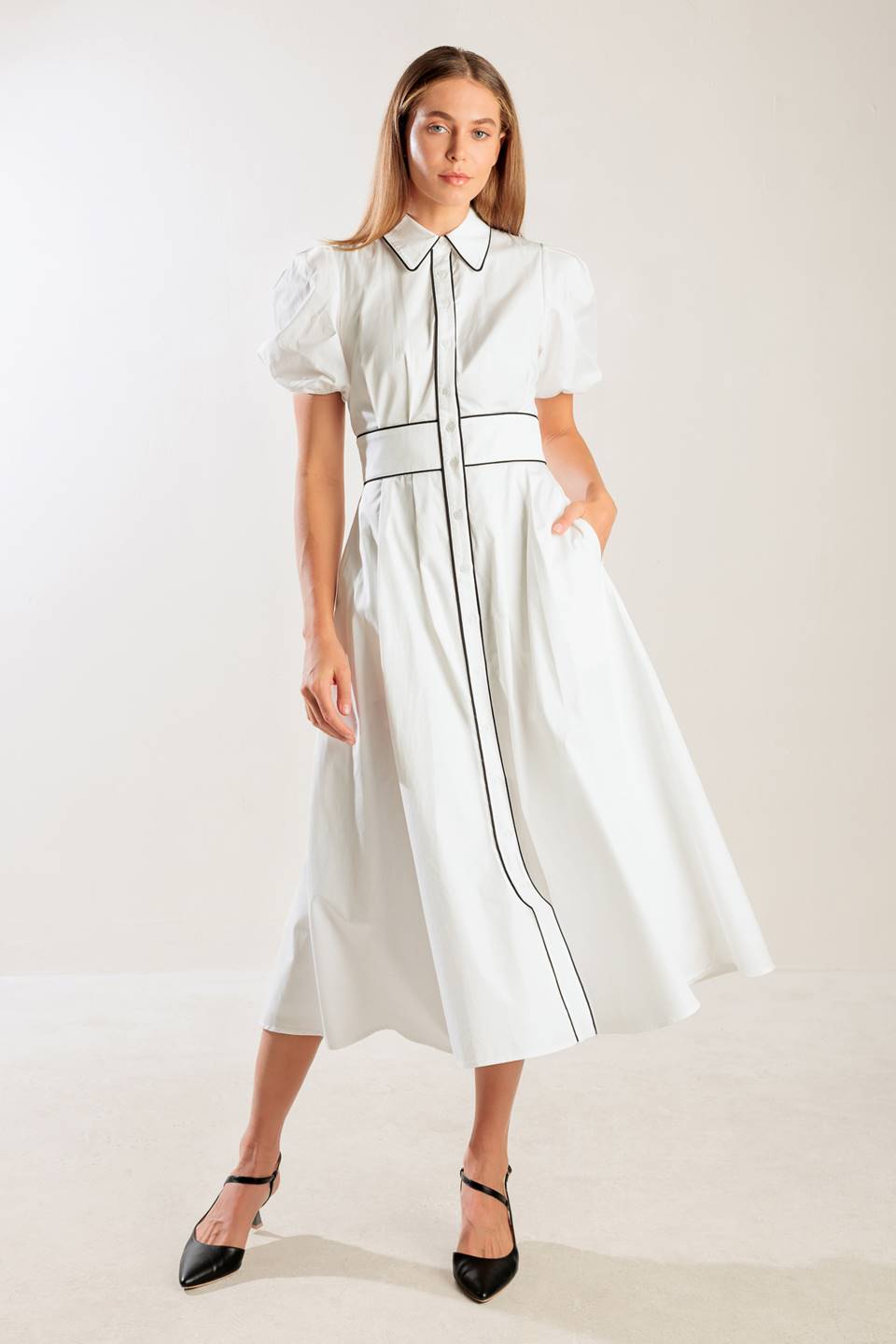 A solid woven midi featuring collar, button down, short puff sleeve, contrasting piping detail and full skirt