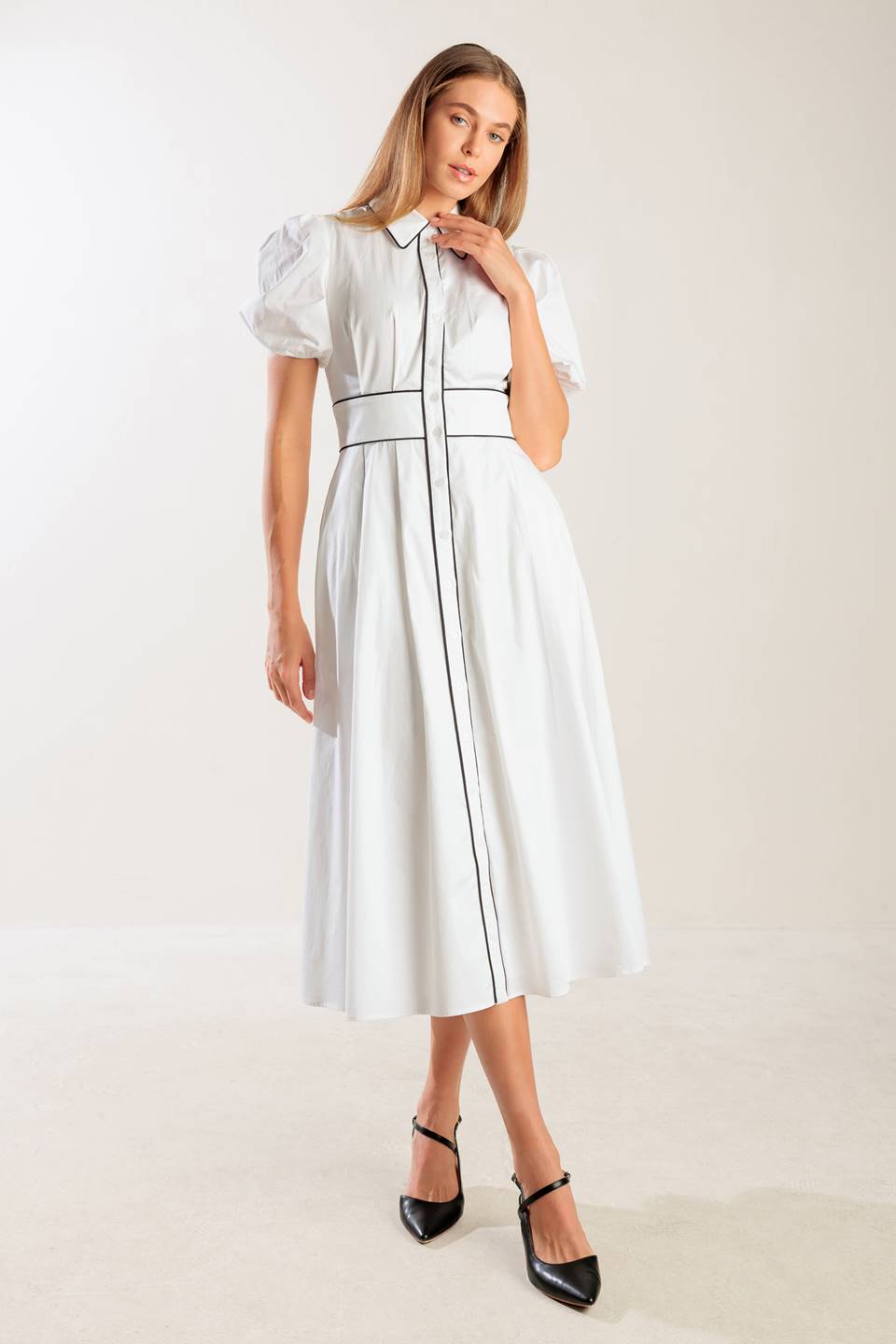 A solid woven midi featuring collar, button down, short puff sleeve, contrasting piping detail and full skirt