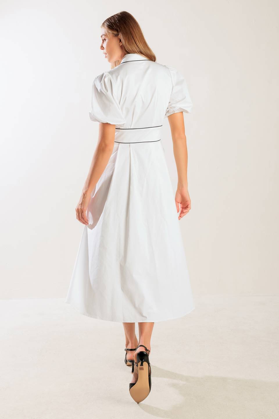 A solid woven midi featuring collar, button down, short puff sleeve, contrasting piping detail and full skirt