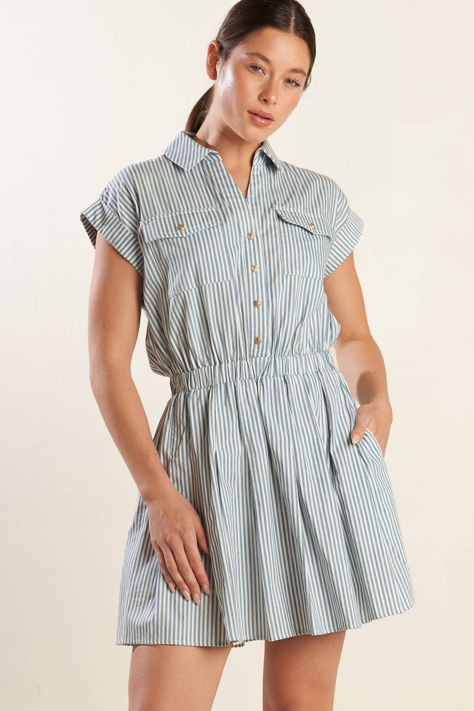 
A striped woven mini dress featuring collar, V neckline, button down bodice, pockets, cuffed short sleeve, elasticized waist and pleated skirt

Self : 100% Cotton

Size &amp; Fit

- Model is 5`8" And Wearing Size Small
- Measurements Taken From Size Small
- Approx. Length: 39"