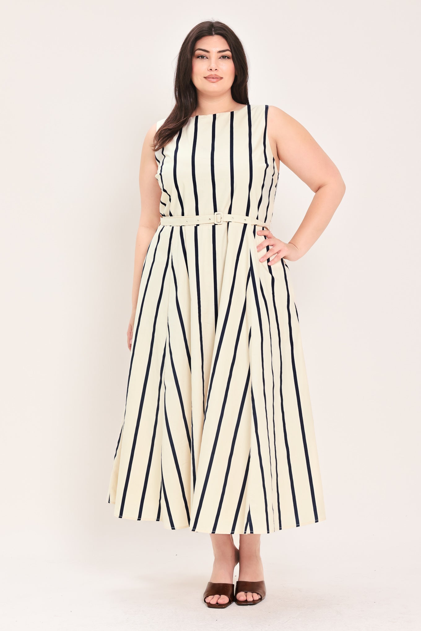 Woman wearing a navy and white striped midi dress featuring wide neckline, sleeveless, self belt, full skirt, low back with zipper closure | FREEMARKET