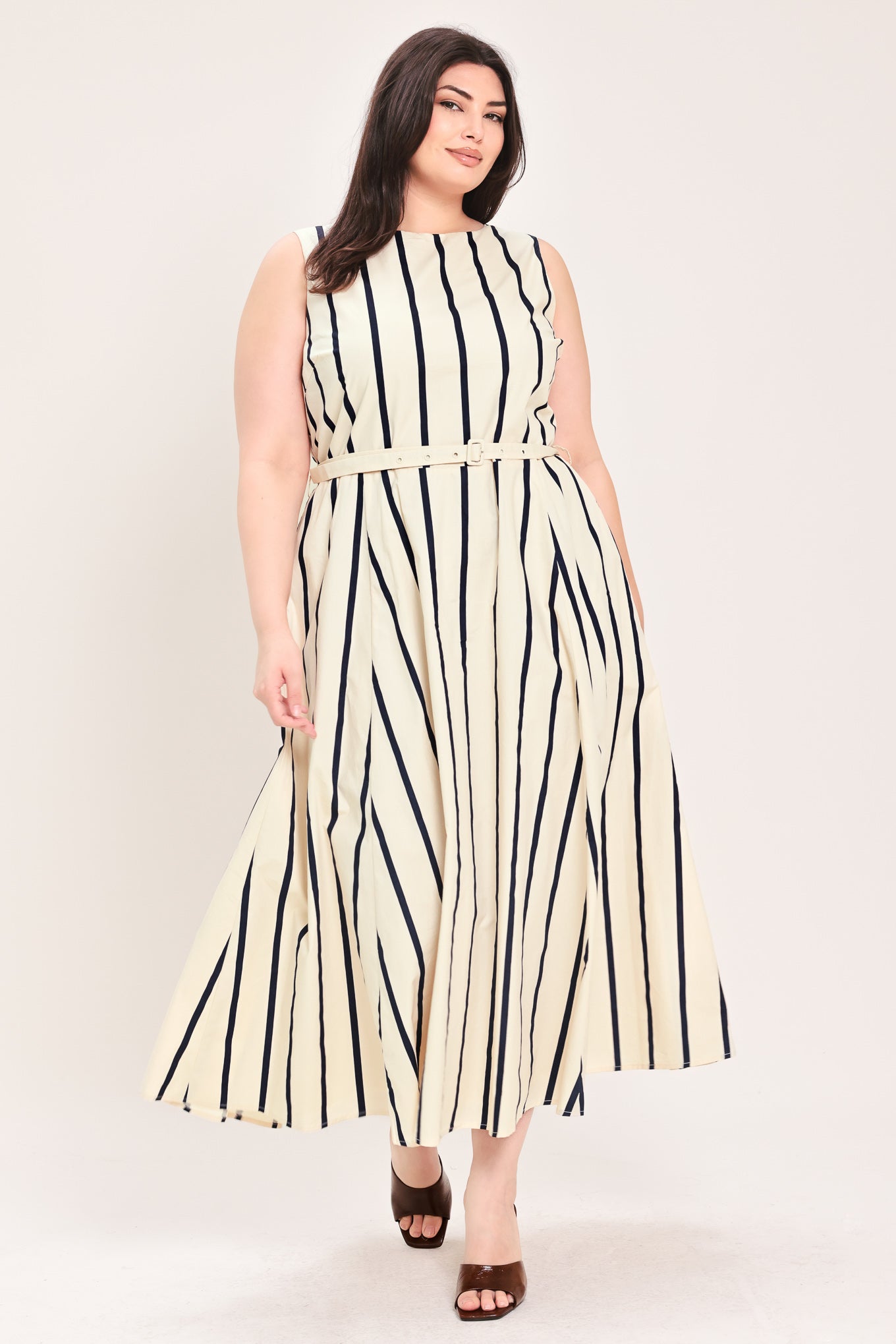 Woman wearing a navy and white striped midi dress featuring wide neckline, sleeveless, self belt, full skirt, low back with zipper closure | FREEMARKET