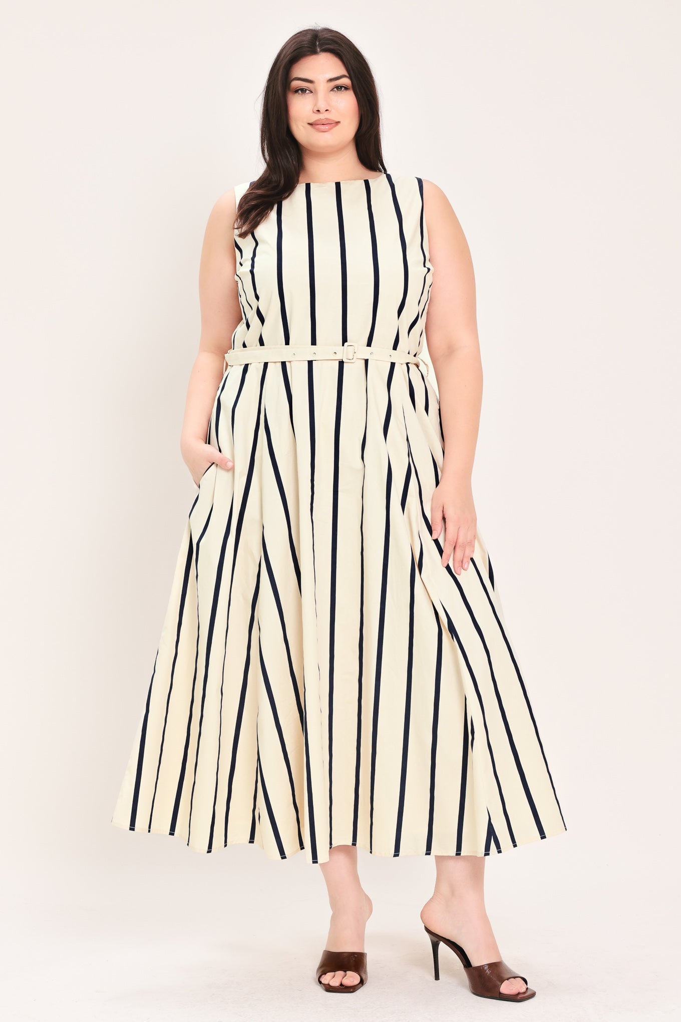 Woman wearing a navy and white striped midi dress featuring wide neckline, sleeveless, self belt, full skirt, low back with zipper closure | FREEMARKET