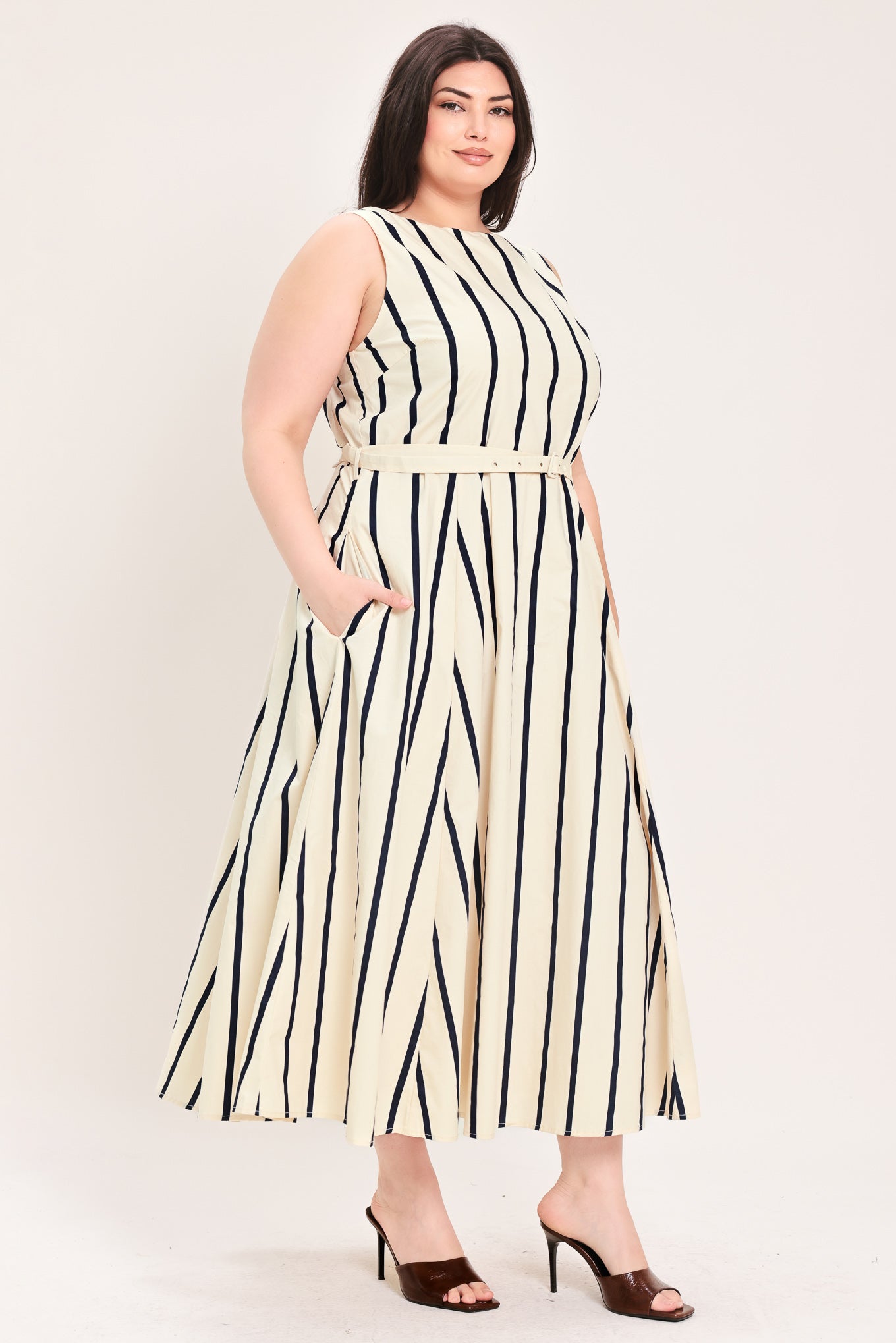 Woman wearing a navy and white striped midi dress featuring wide neckline, sleeveless, self belt, full skirt, low back with zipper closure | FREEMARKET