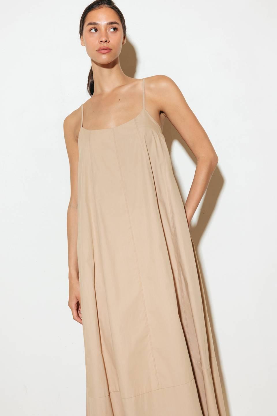 Crafted with a solid woven texture and a stylish taupe hue, this midi tent dress offers a versatile addition to your wardrobe. Featuring a convenient back strap closure, it's a functional and chic option for any occasion.