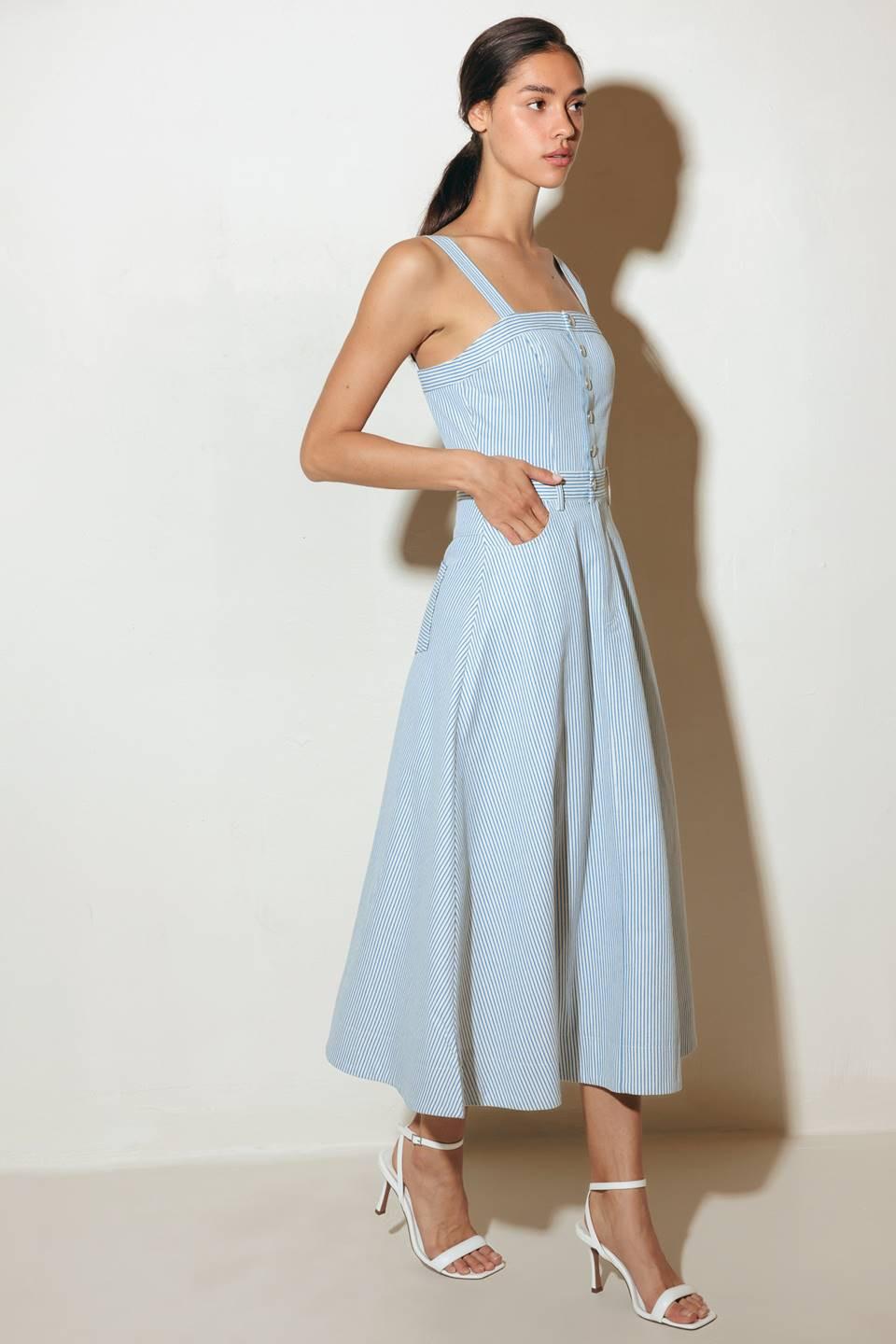 A striped woven midi dress featuring straight neckline, straps, front button down and zipper closure and A line skirt.