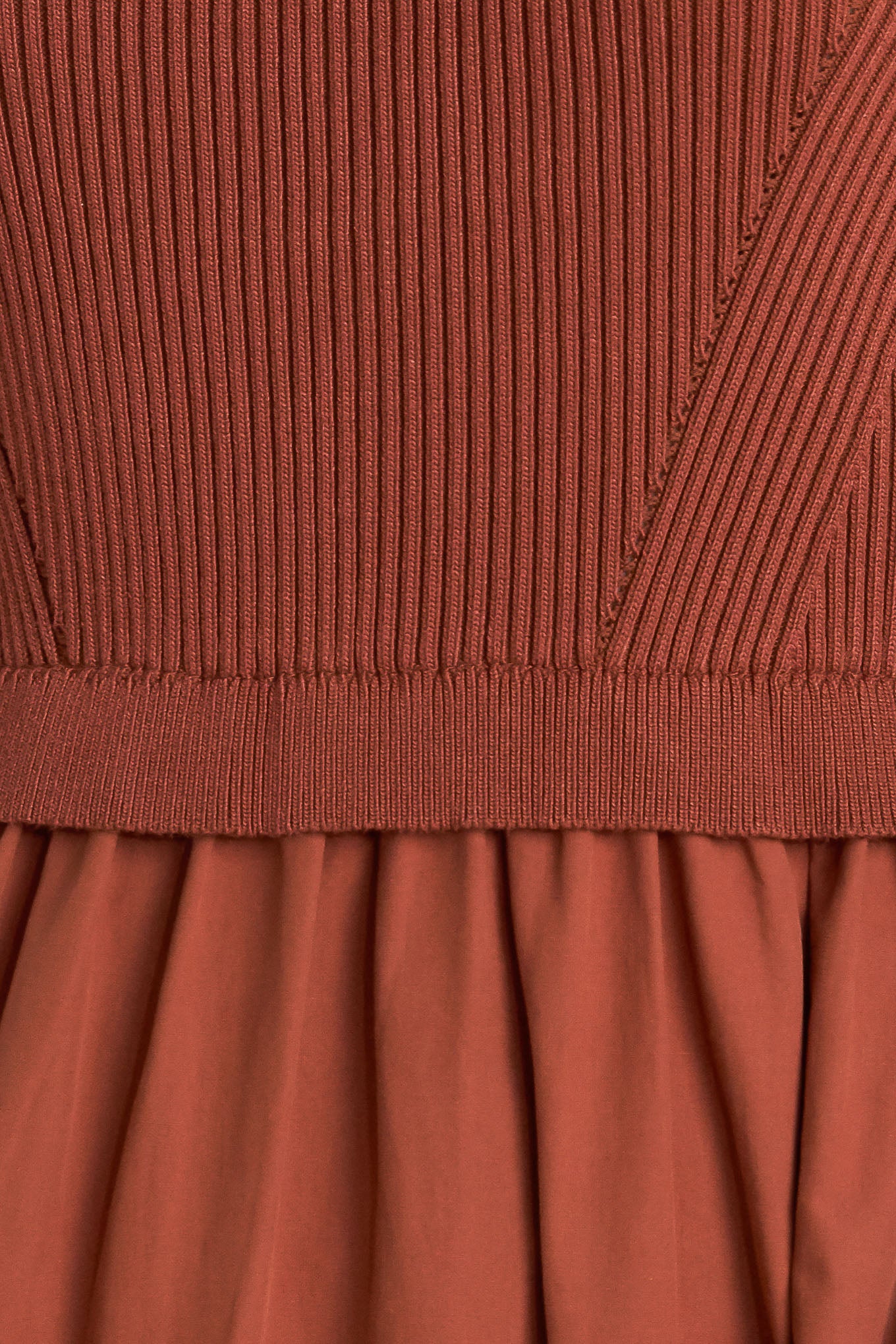 A sweater knit and woven combination midi dress featuring ribbed top with high neckline and short sleeve and tiered woven skirt