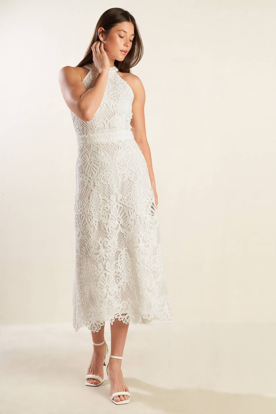 A white woven lace midi dress featuring halter neckline, A-line skirt and back zipper closure.