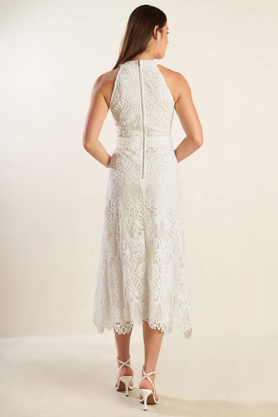 A white woven lace midi dress featuring halter neckline, A-line skirt and back zipper closure.