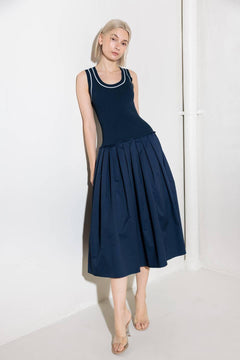 A ribbed sweater knit top and woven skirt combination dress featuring U neckline and sleeveless.