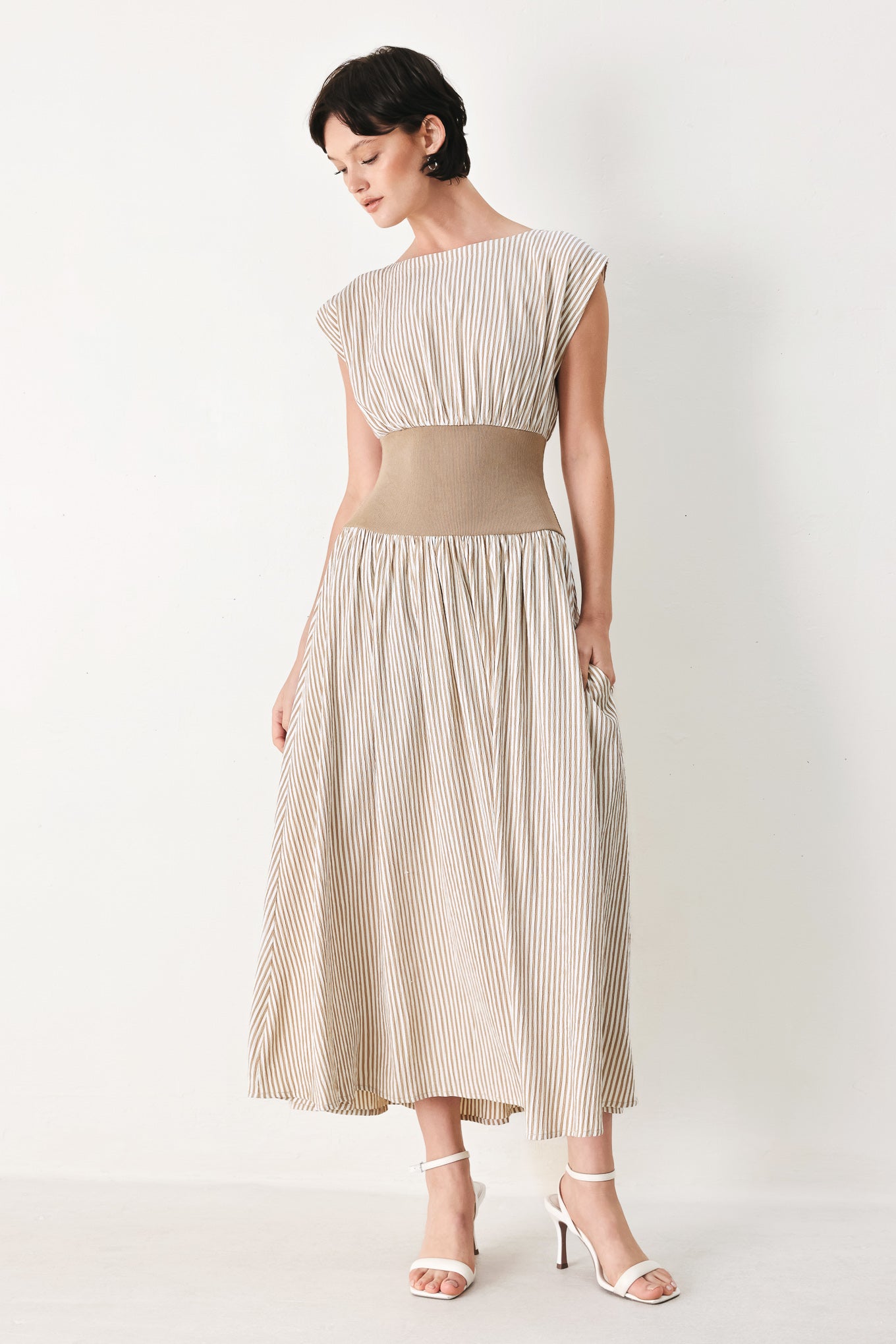 Woman wearing a beige mocha and white cream striped midi dress midi dress featuring wide neckline, cap sleeve, wide ribbed knit waist, full skirt and back zipper | FREEMARKET