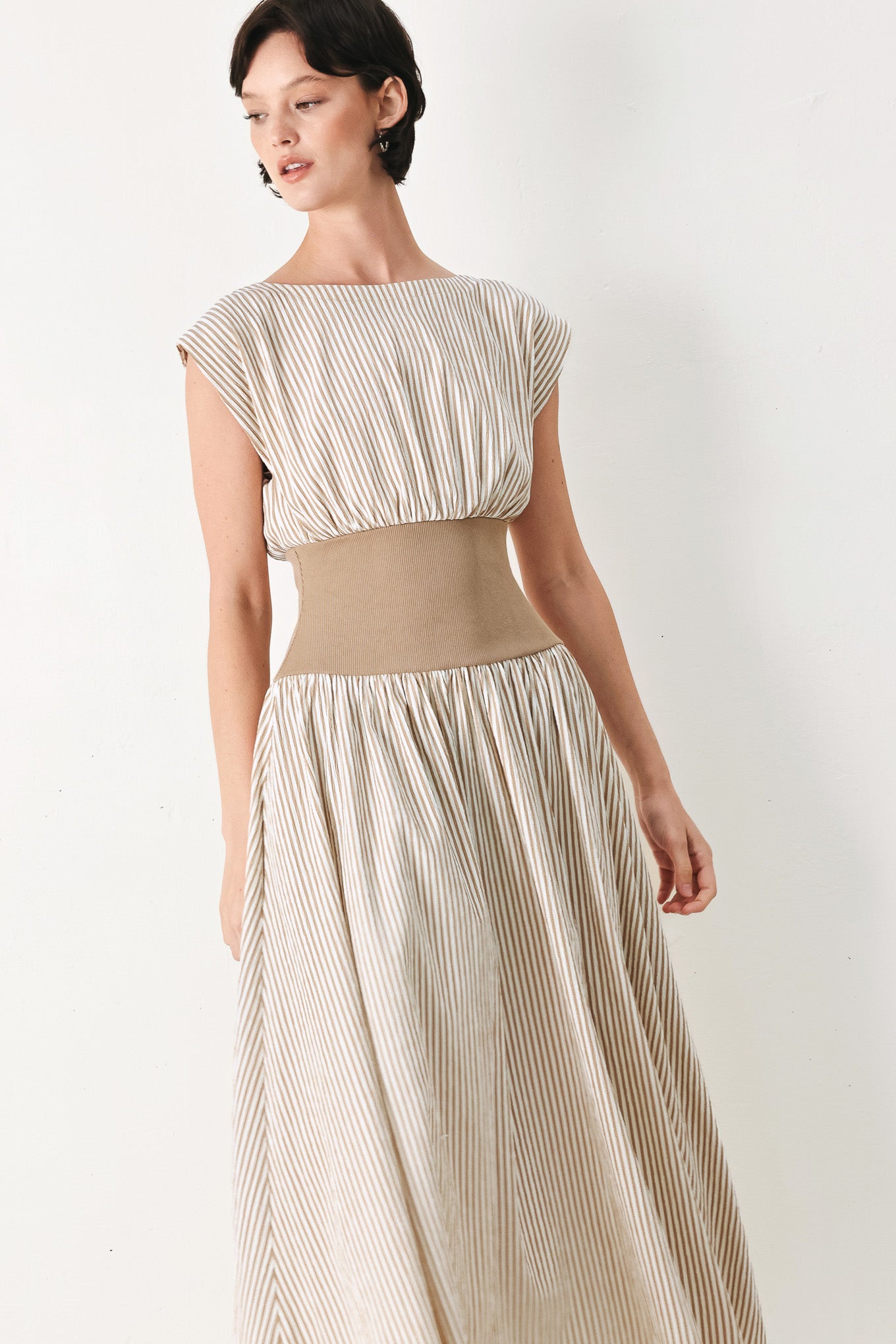 Woman wearing a beige mocha and white cream striped midi dress midi dress featuring wide neckline, cap sleeve, wide ribbed knit waist, full skirt and back zipper | FREEMARKET