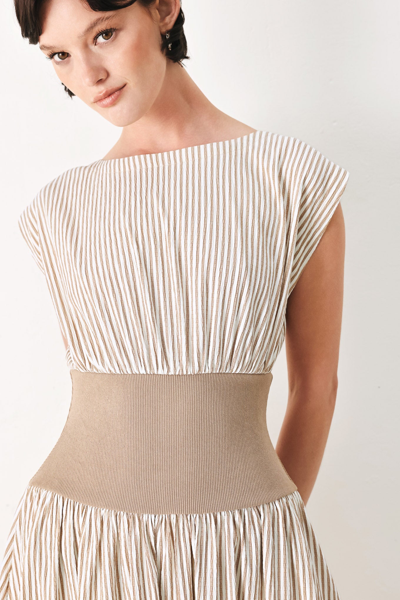 Woman wearing a beige mocha and white cream striped midi dress midi dress featuring wide neckline, cap sleeve, wide ribbed knit waist, full skirt and back zipper | FREEMARKET