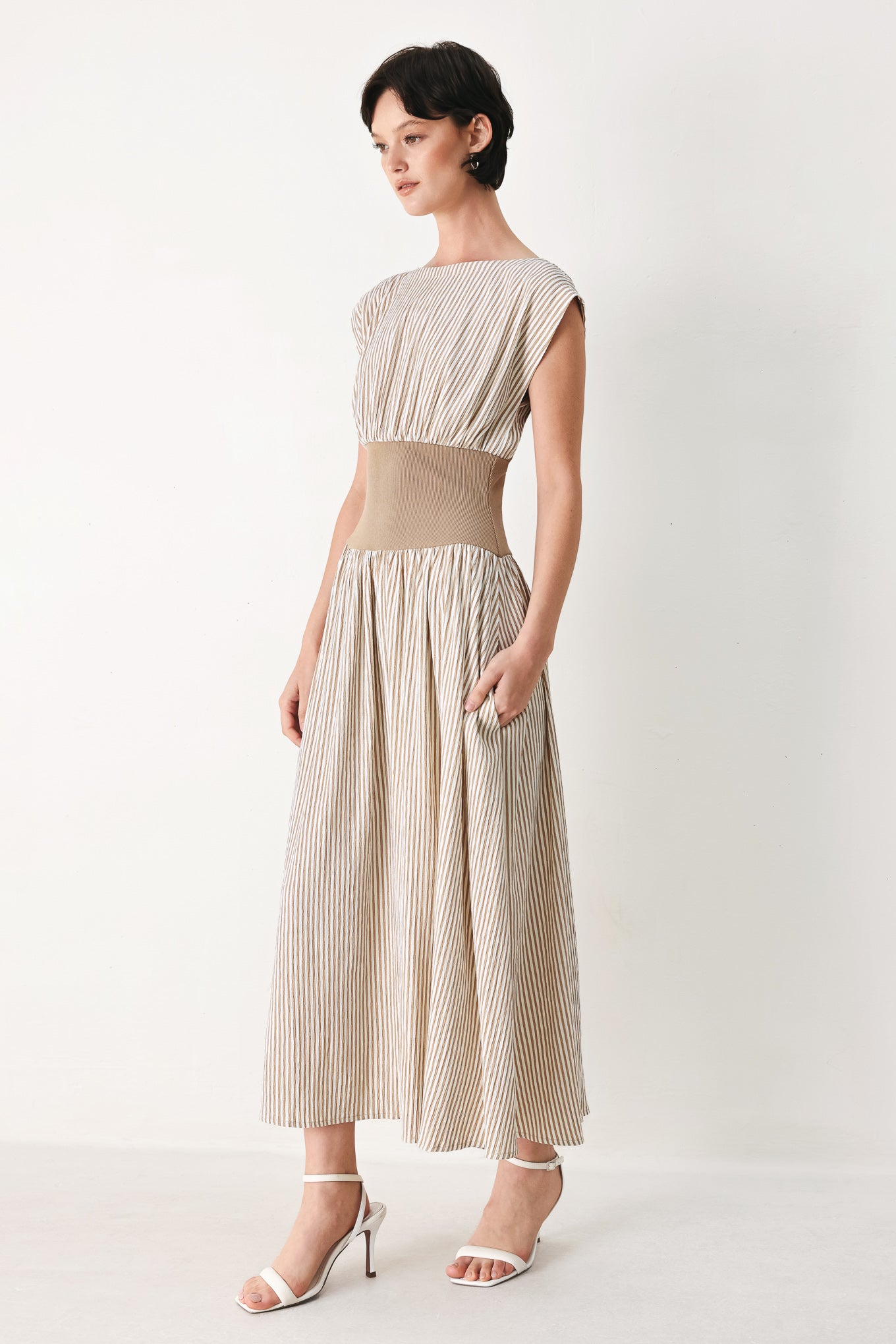 Woman wearing a beige mocha and white cream striped midi dress midi dress featuring wide neckline, cap sleeve, wide ribbed knit waist, full skirt and back zipper | FREEMARKET