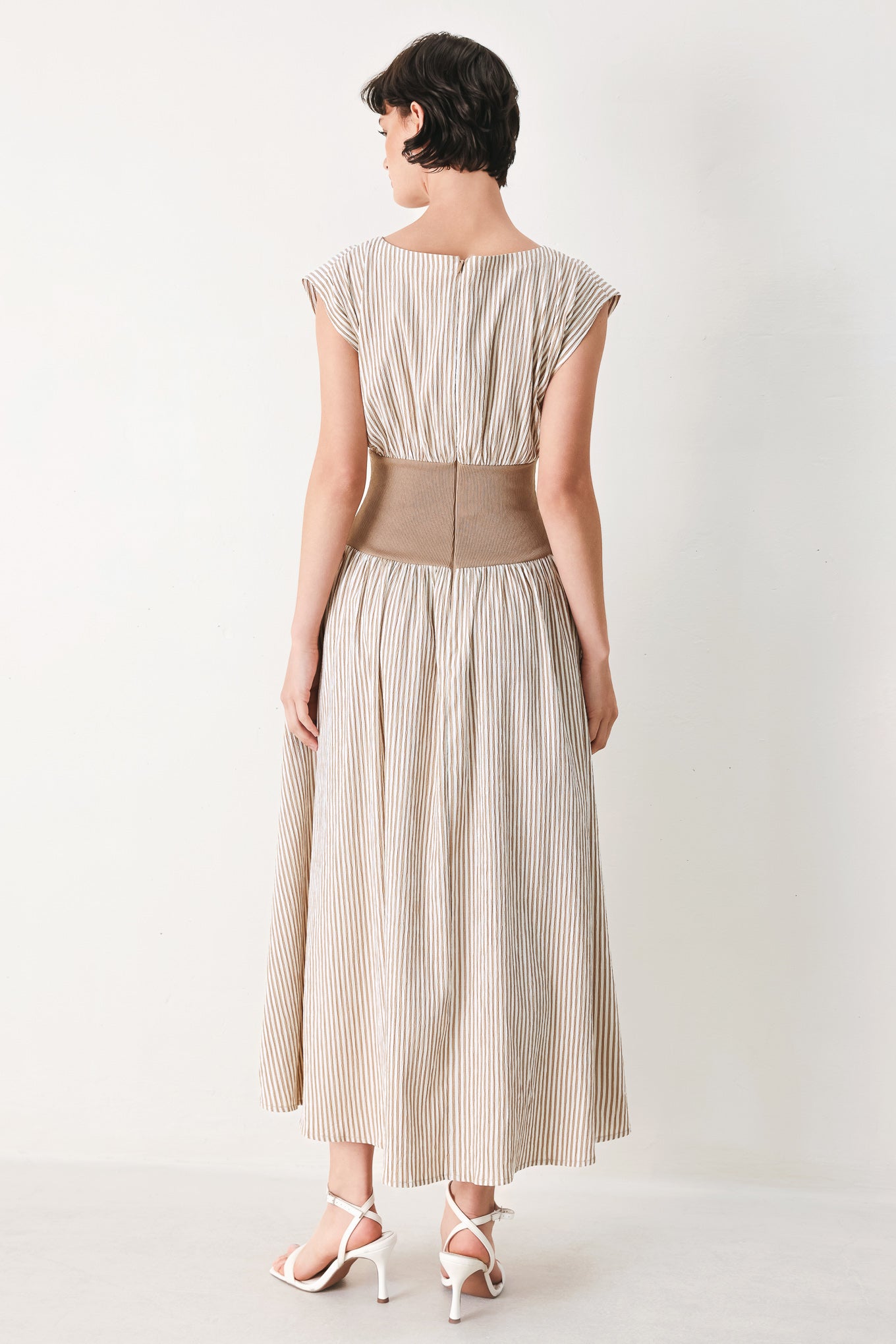 Woman wearing a beige mocha and white cream striped midi dress midi dress featuring wide neckline, cap sleeve, wide ribbed knit waist, full skirt and back zipper | FREEMARKET