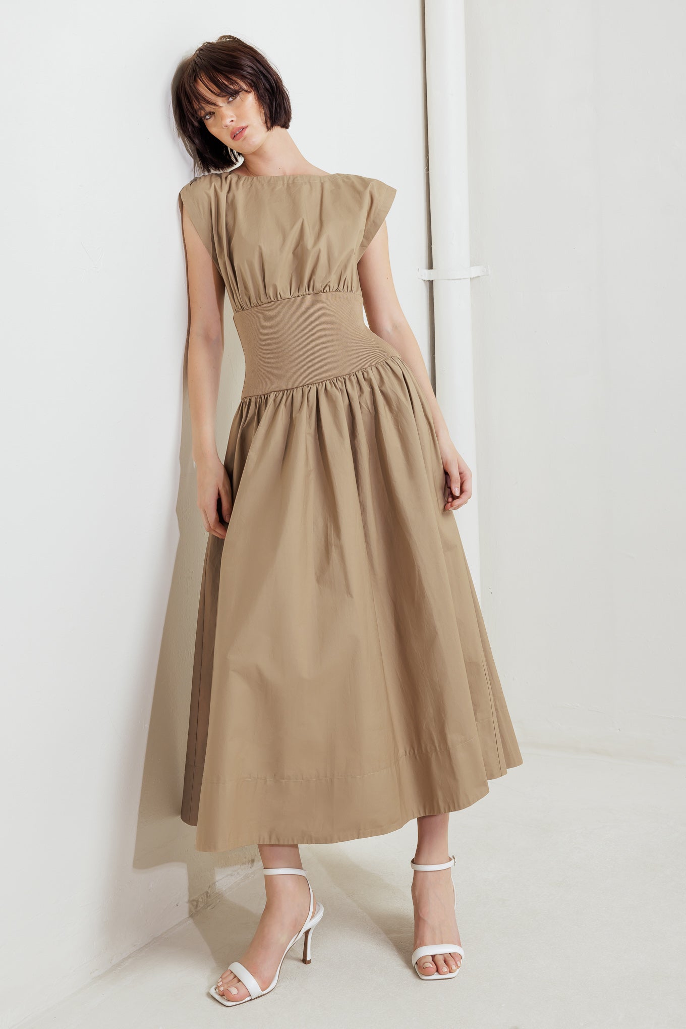 A solid woven midi dress featuring wide neckline, short sleeve, knit midriff, full skirt and back zipper closure