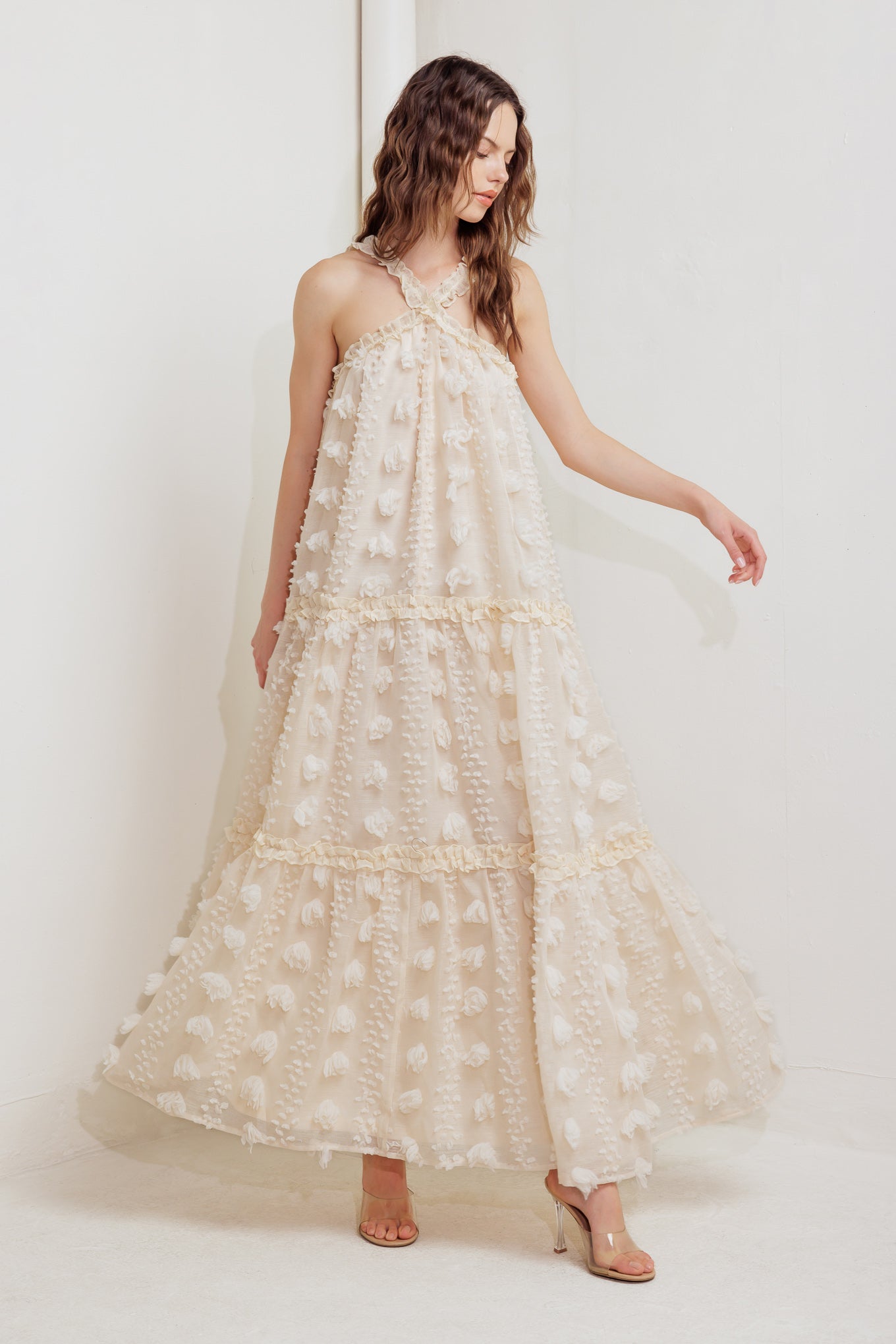 A textured woven ankle dress featuring ruffled cross front and tiered skirt