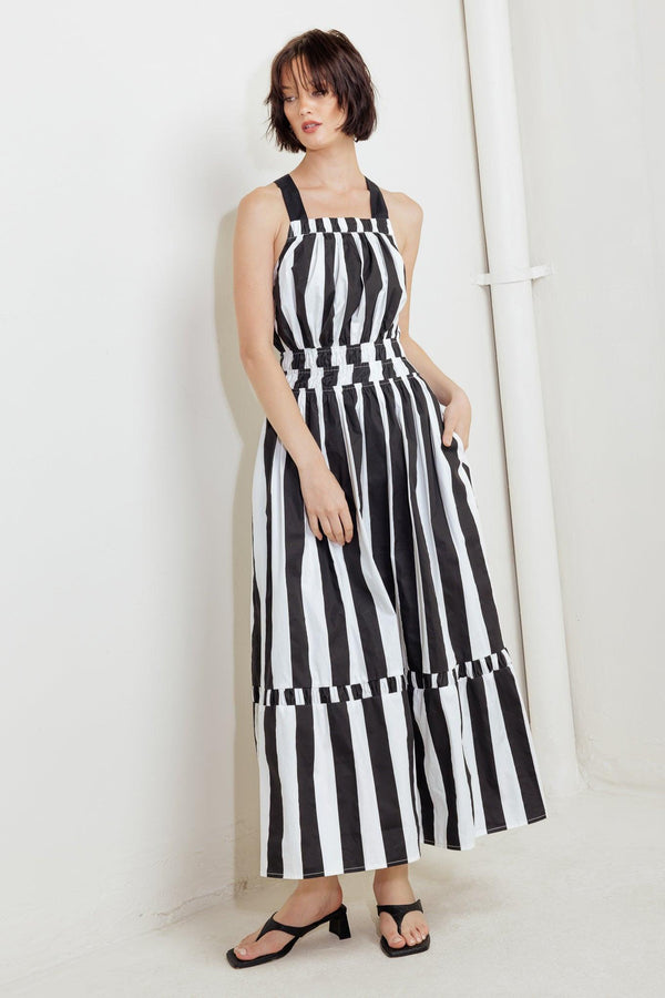 A striped woven midi dress featuring straight neckline, elasticized waist, bare back with cross strap and tie closure