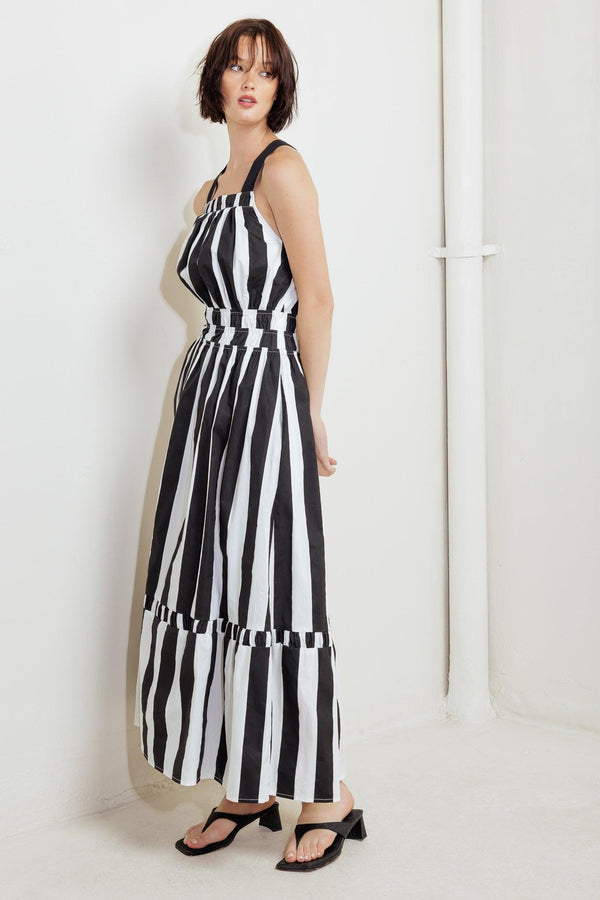 A striped woven midi dress featuring straight neckline, elasticized waist, bare back with cross strap and tie closure