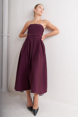 A solid woven mid dress featuring strapless, self belt, full skirt and back zipper closure