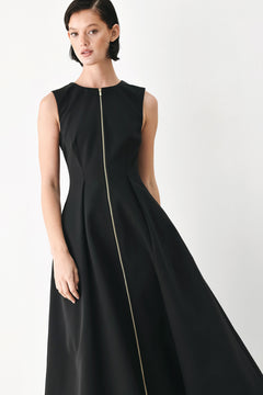A woman modeling a sleeveless black midi dress with a prominent gold front zipper | FREEMARKET