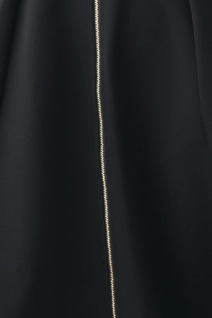 A woman modeling a sleeveless black midi dress with a prominent gold front zipper | FREEMARKET