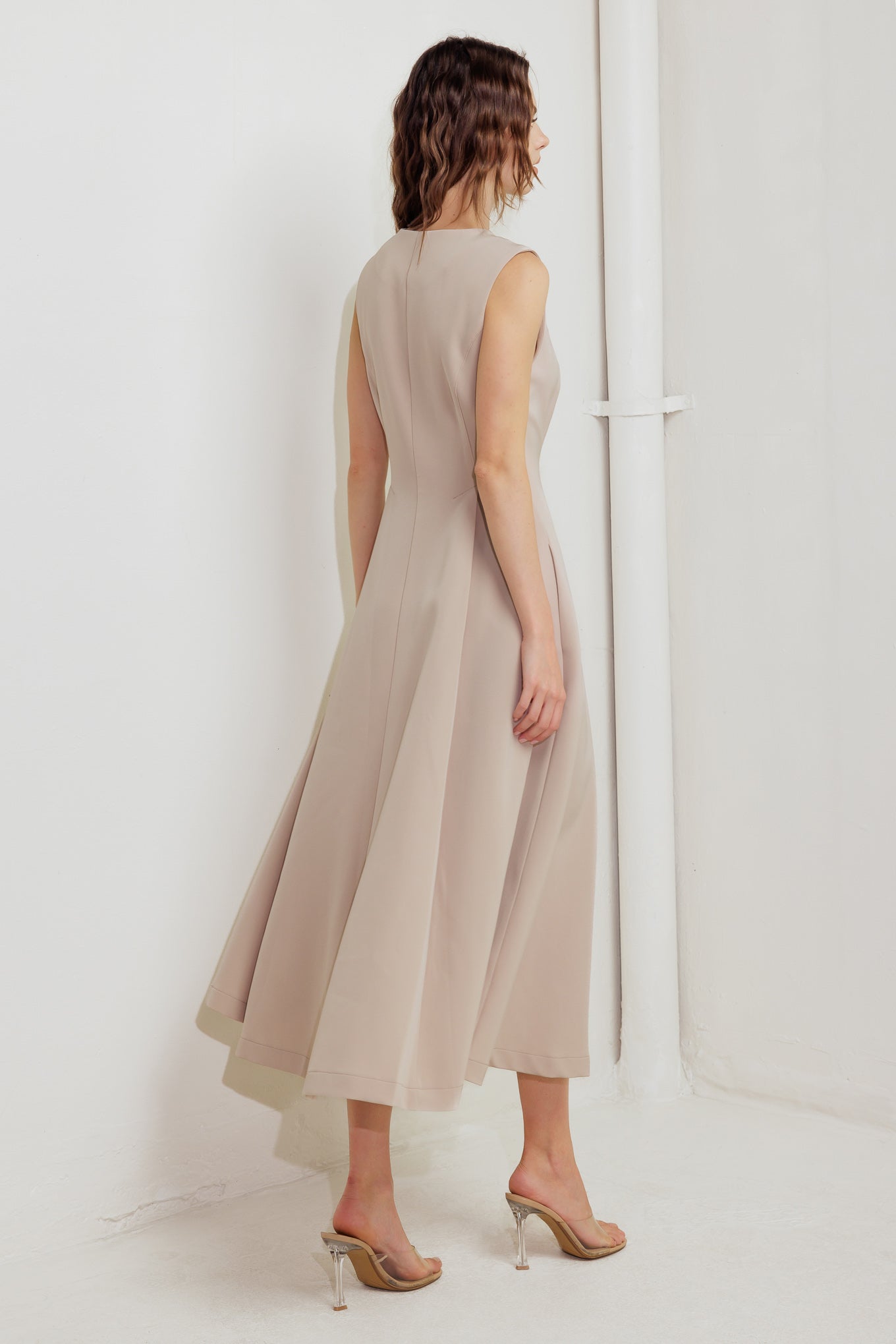 A solid woven midi dress featuring round neckline, sleeveless, front zipper closure and full skirt
