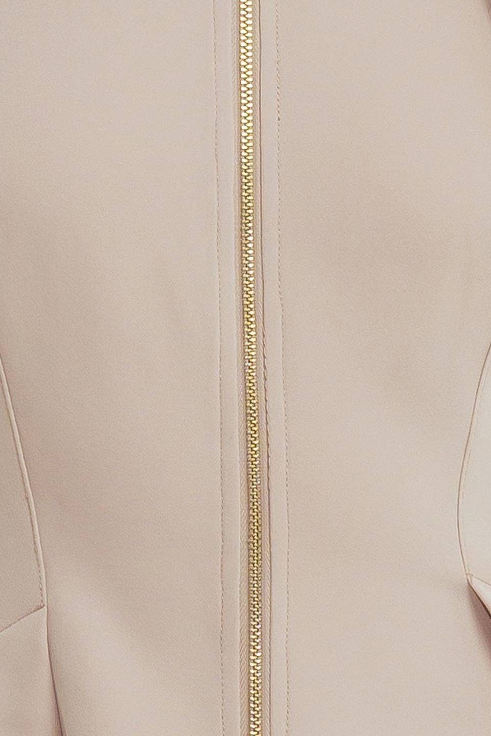 A woman modeling a sleeveless beige midi dress with a prominent gold front zipper | FREEMARKET