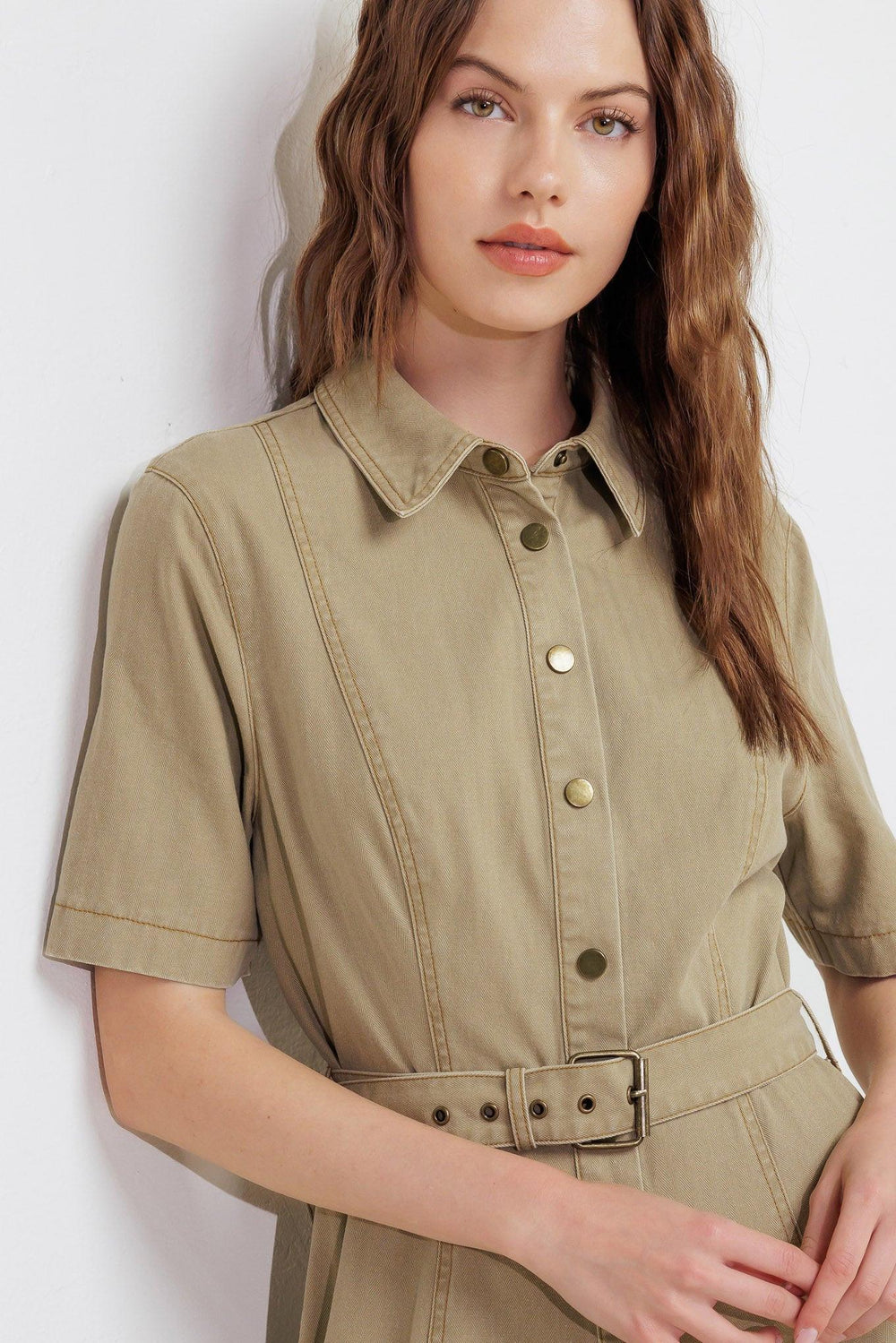 A solid woven midi dress featuring collar, short sleeve, button down, self belt and circle skirt
