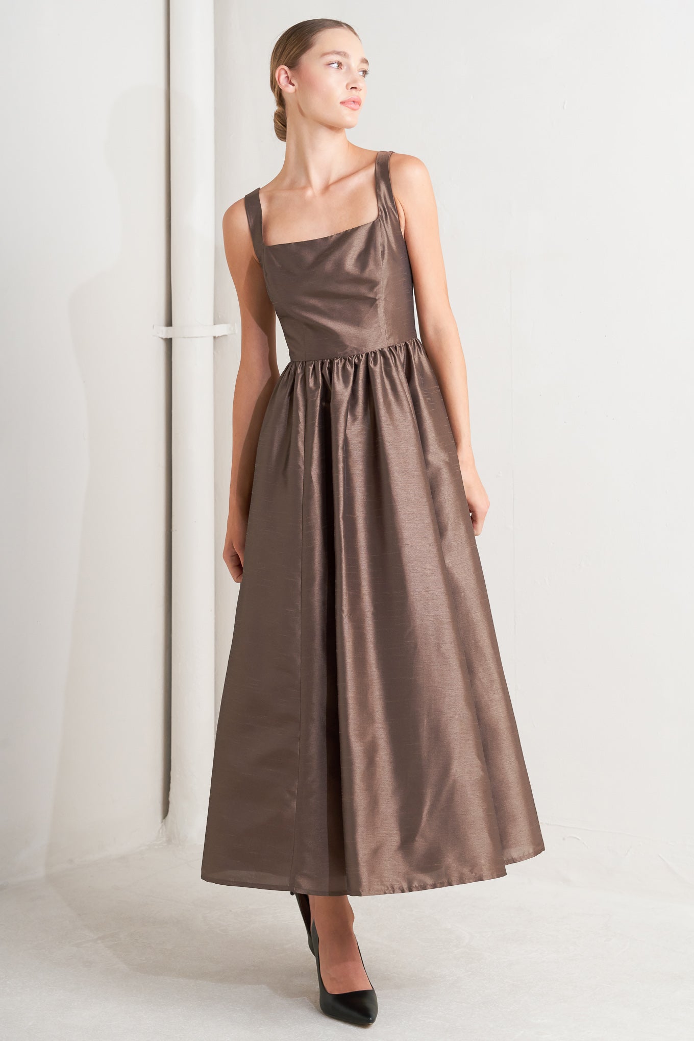 A solid woven midi dress featuring straight neckline, sleeveless, full skirt, back lace up detail and side zipper closure