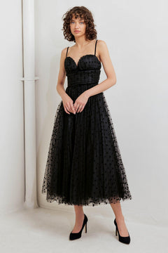 A dot tulle midi dress featuring sweetheart neckline, straps, full skirt and back zipper closure