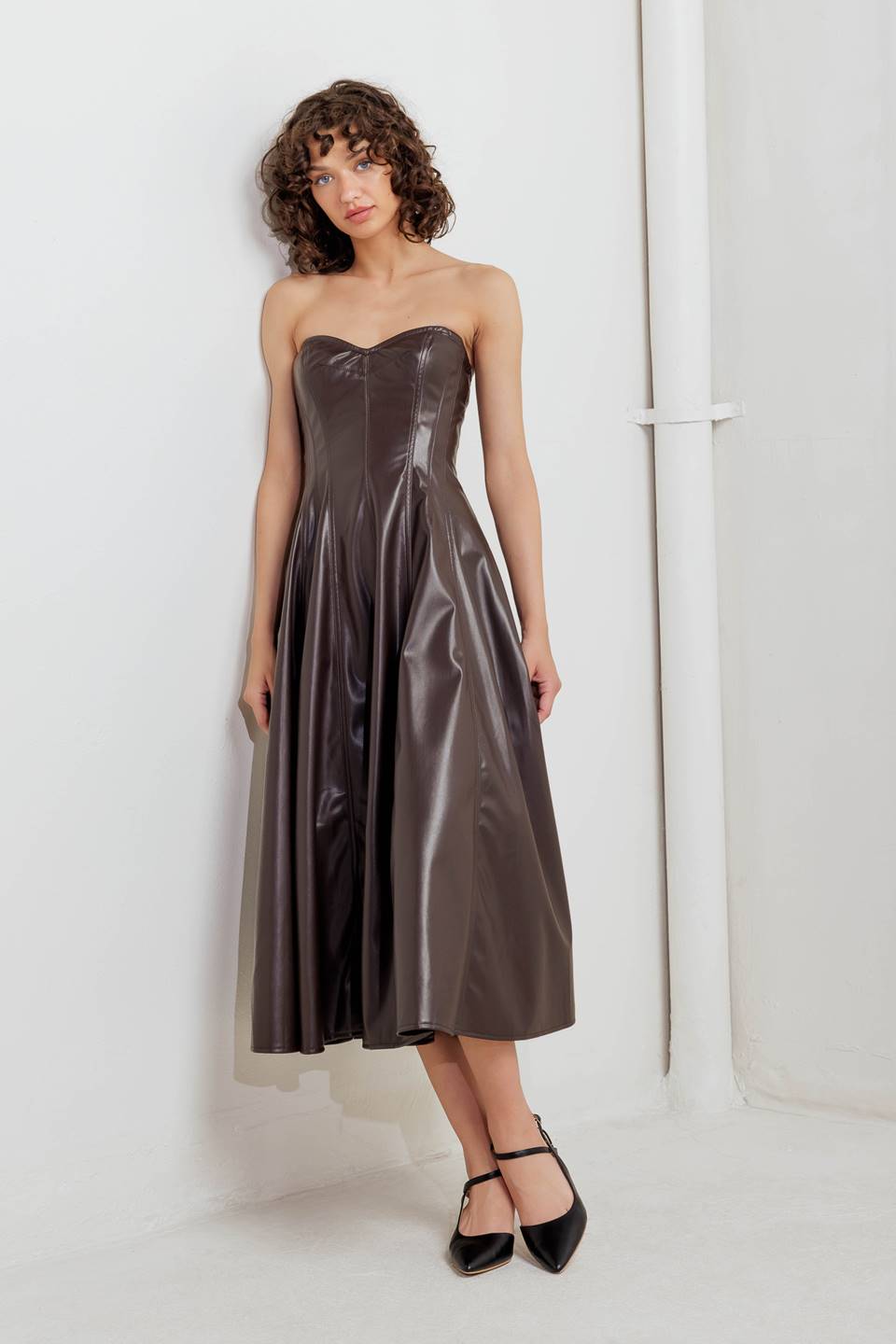 A faux leather midi dress featuring strapless sweetheart neckline, circle skirt and back zipper closure