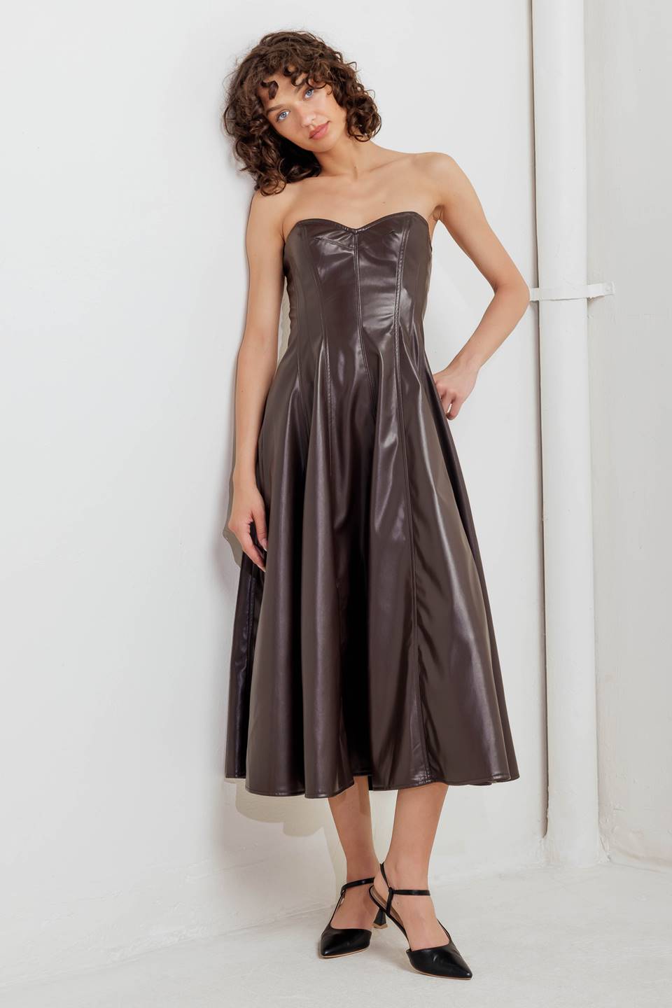 A faux leather midi dress featuring strapless sweetheart neckline, circle skirt and back zipper closure