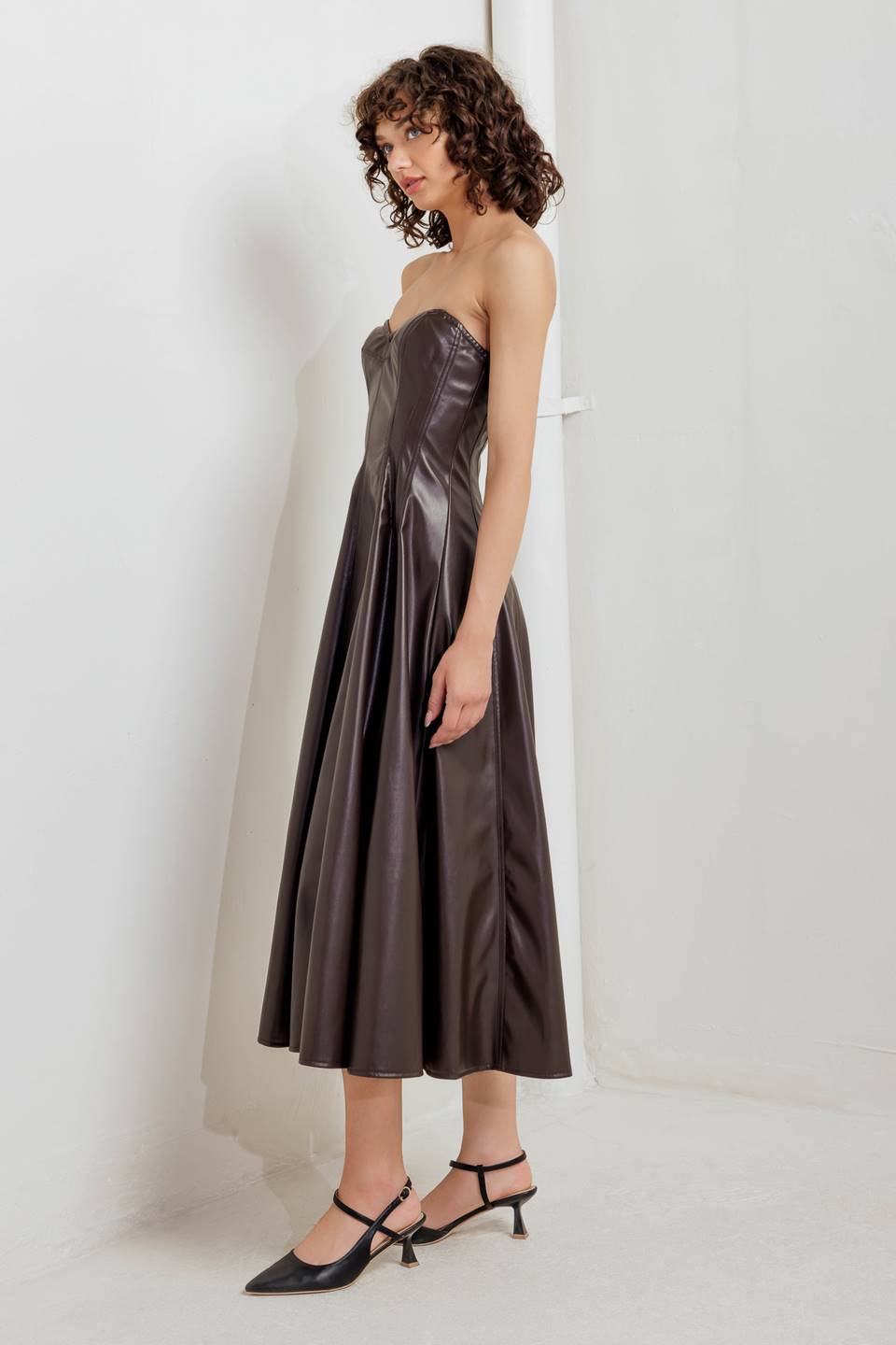 A faux leather midi dress featuring strapless sweetheart neckline, circle skirt and back zipper closure