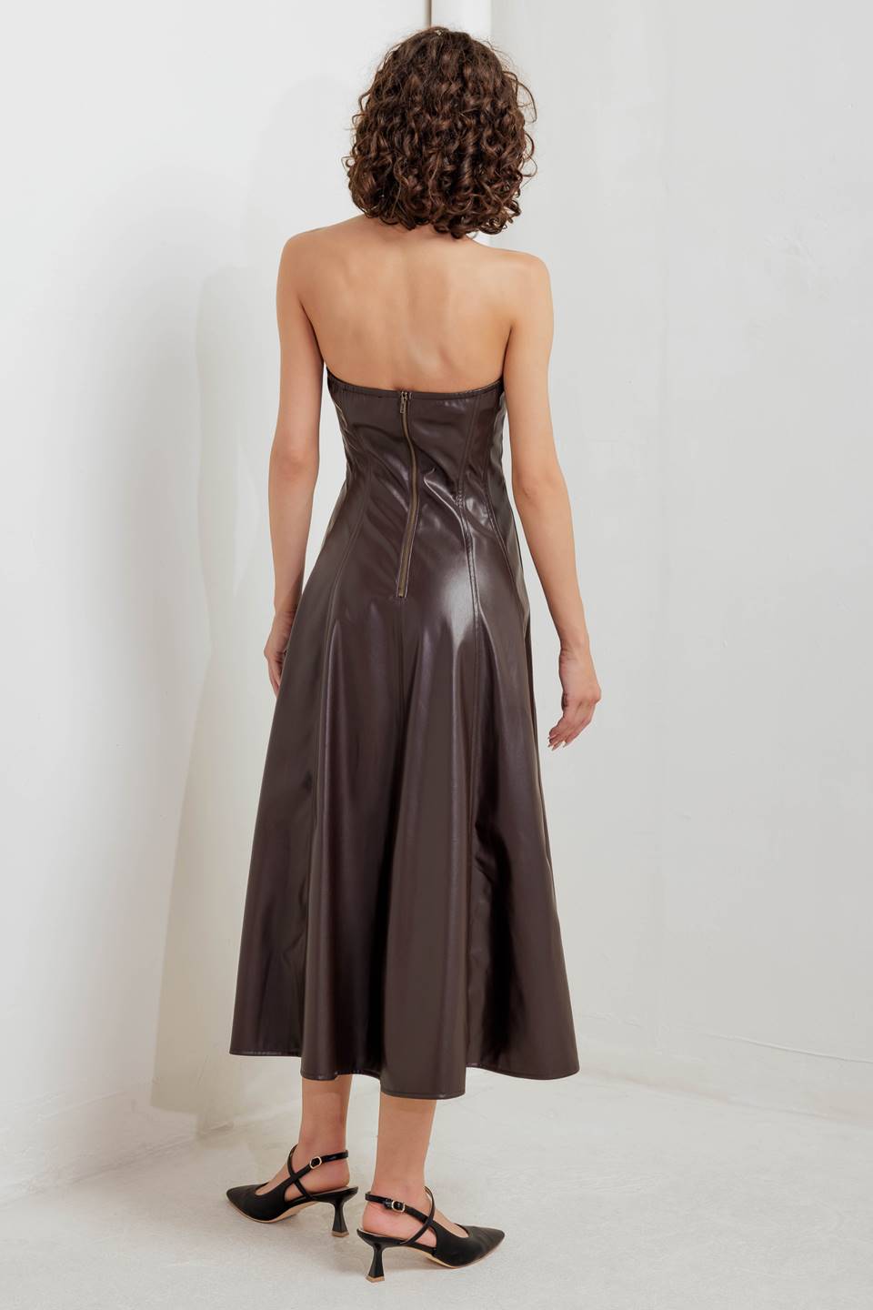 A faux leather midi dress featuring strapless sweetheart neckline, circle skirt and back zipper closure