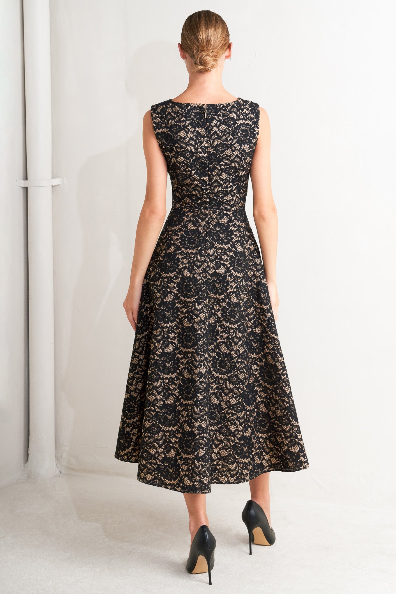 A woven lace midi dress featuring wide neckline, sleeveless, circle skirt and back zipper closure